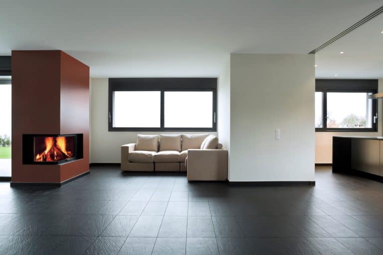A spacious and minimalist designed living room with black tiles and a fireplace on the middle, Is Epoxy Grout Waterproof? Here's what you need to know