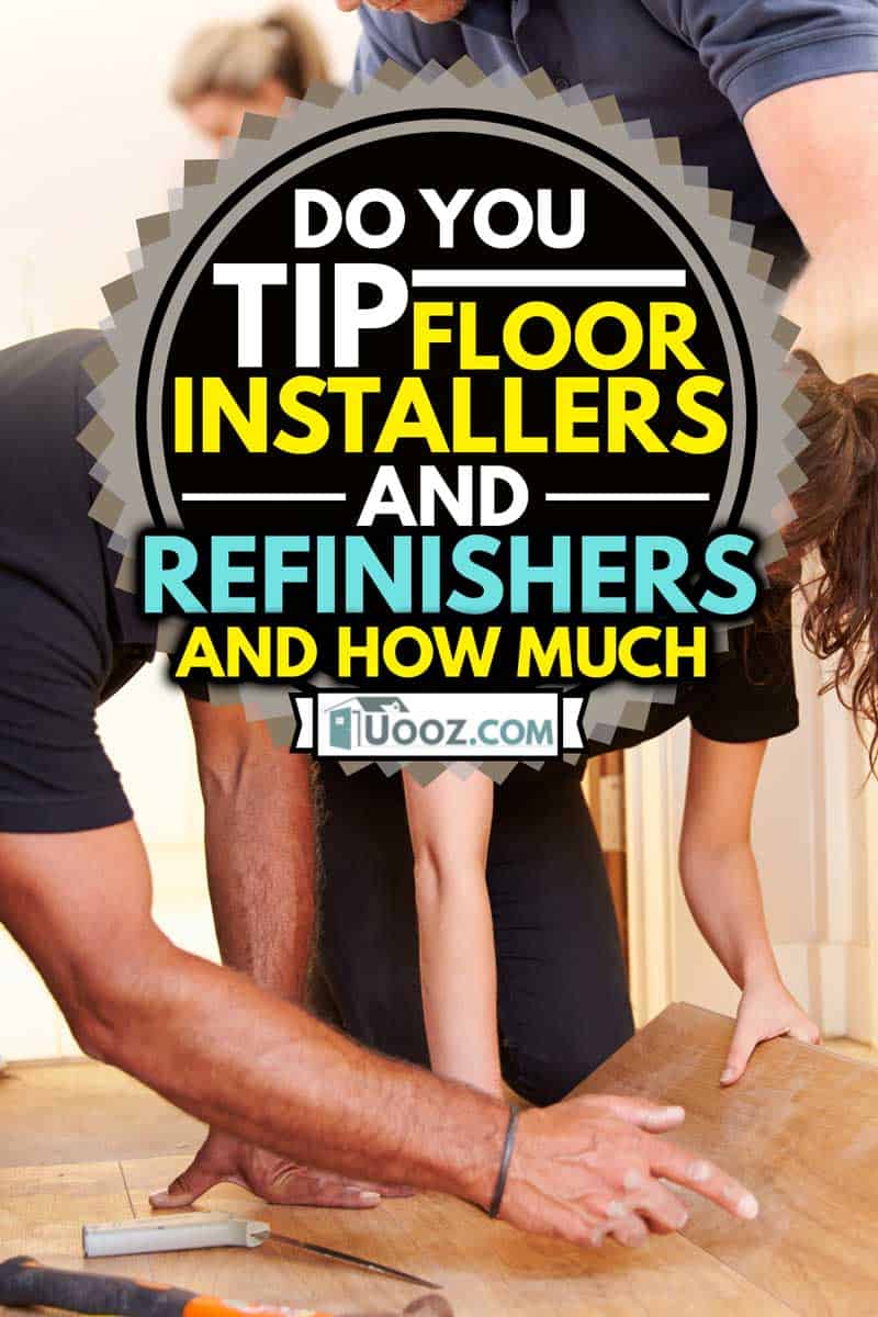 Man and woman laying wood panel flooring in a house, Do You Tip Floor Installers And Refinishers (And How Much)?