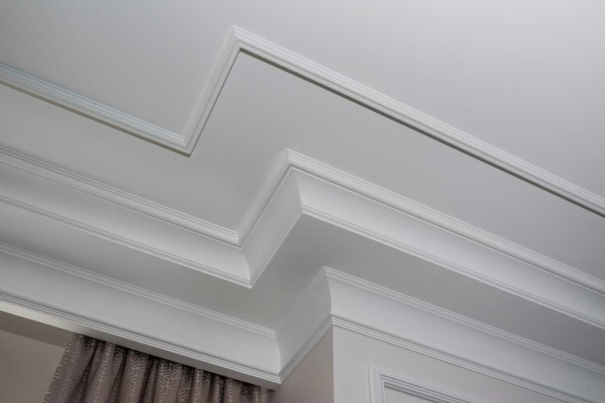 Detail of intricate corner crown molding. a detail of corner ceiling, How to Cut Crown Molding? [4 Steps]