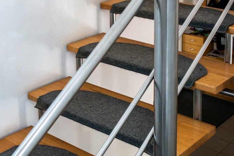 Indoor hollow staircase with carpet and safety hand rails, How To Carpet Open Riser Stairs? [8 Steps]