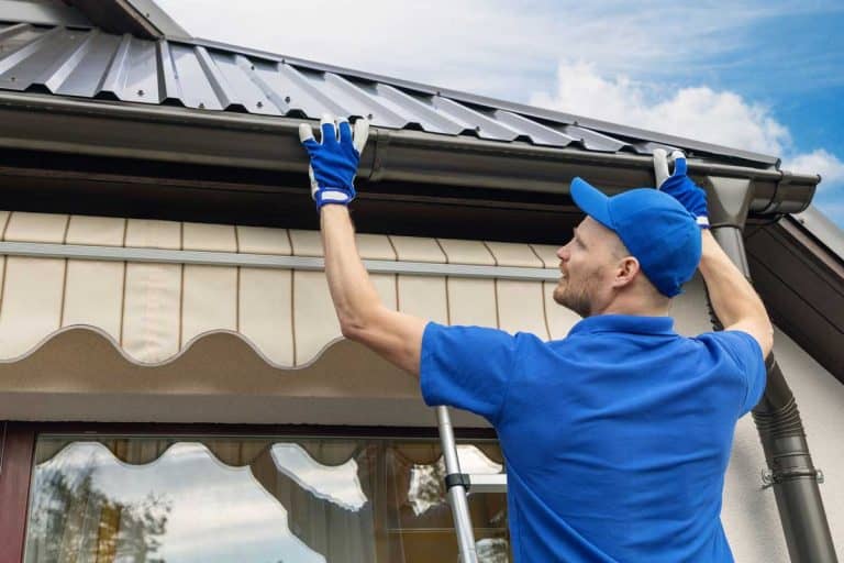 man installing house roof rain gutter system, Are Gutters Hard to Install? [Can This Be Your Next DIY Project?]