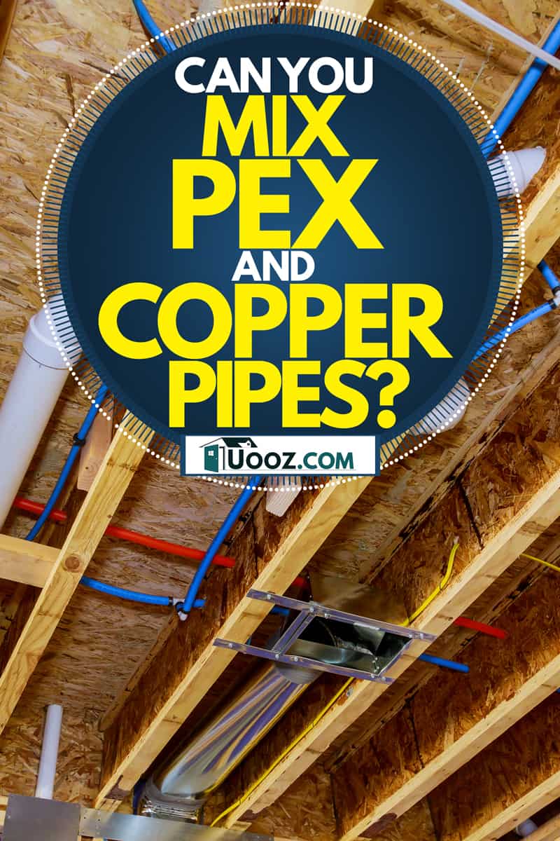 A series of PEX pipes running through the ceiling of a house next to plumbing lines, Can You Mix PEX And Copper Pipes?