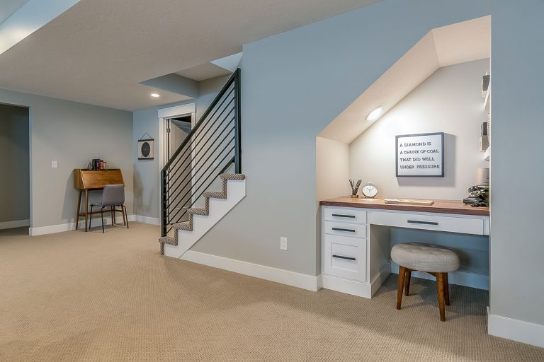 Basement rec room with home office desk underneath the stairs, Is The Basement Considered A Story?
