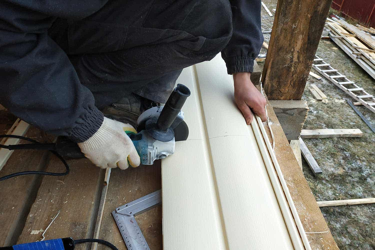 An employee cuts siding to the required size