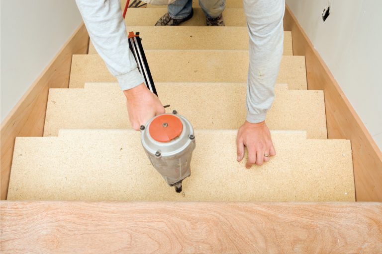 Carpenter installing pre-made stairs by hand, Can You Buy Pre-Made Stairs (And How Much Do They Cost)
