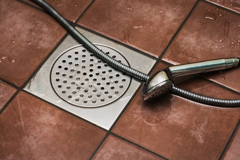 Shower drain and shower head in bathroom floor, 4 Types Of Floor Drains To Know