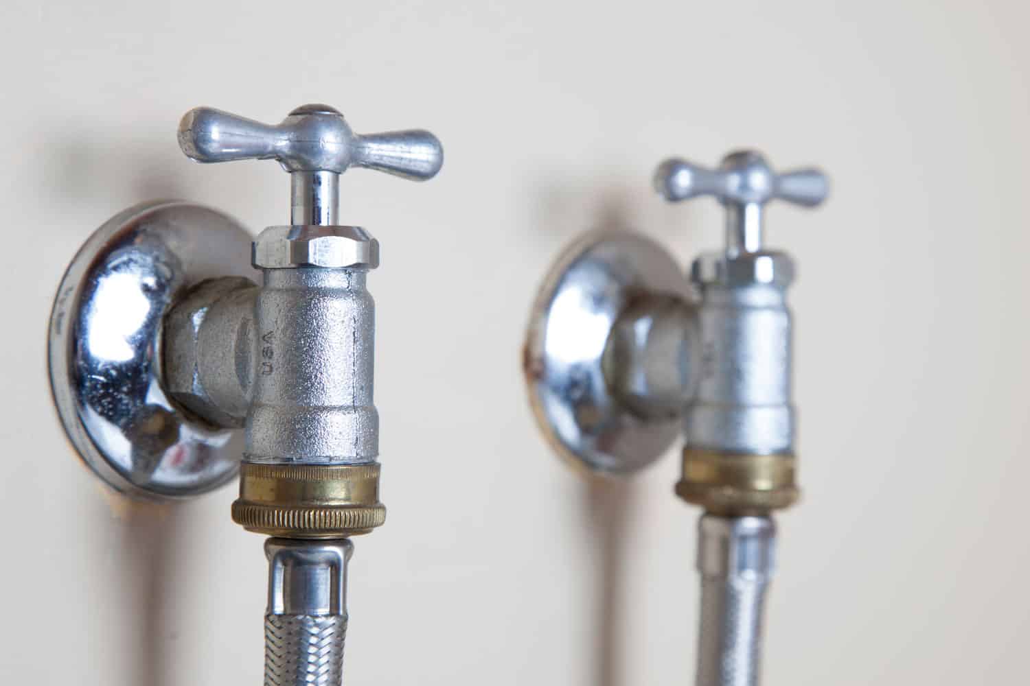 Two galvanized iron faucets for hot and cold water lines