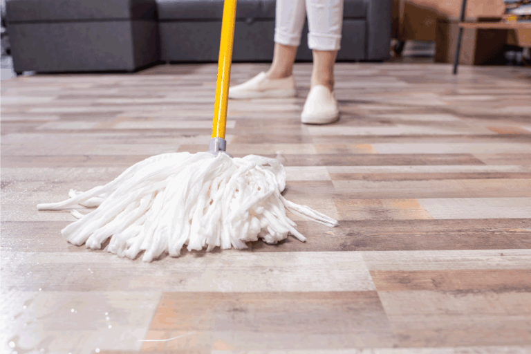 Woman cleaning floor with mop. Should You Dry The Floor After Mopping