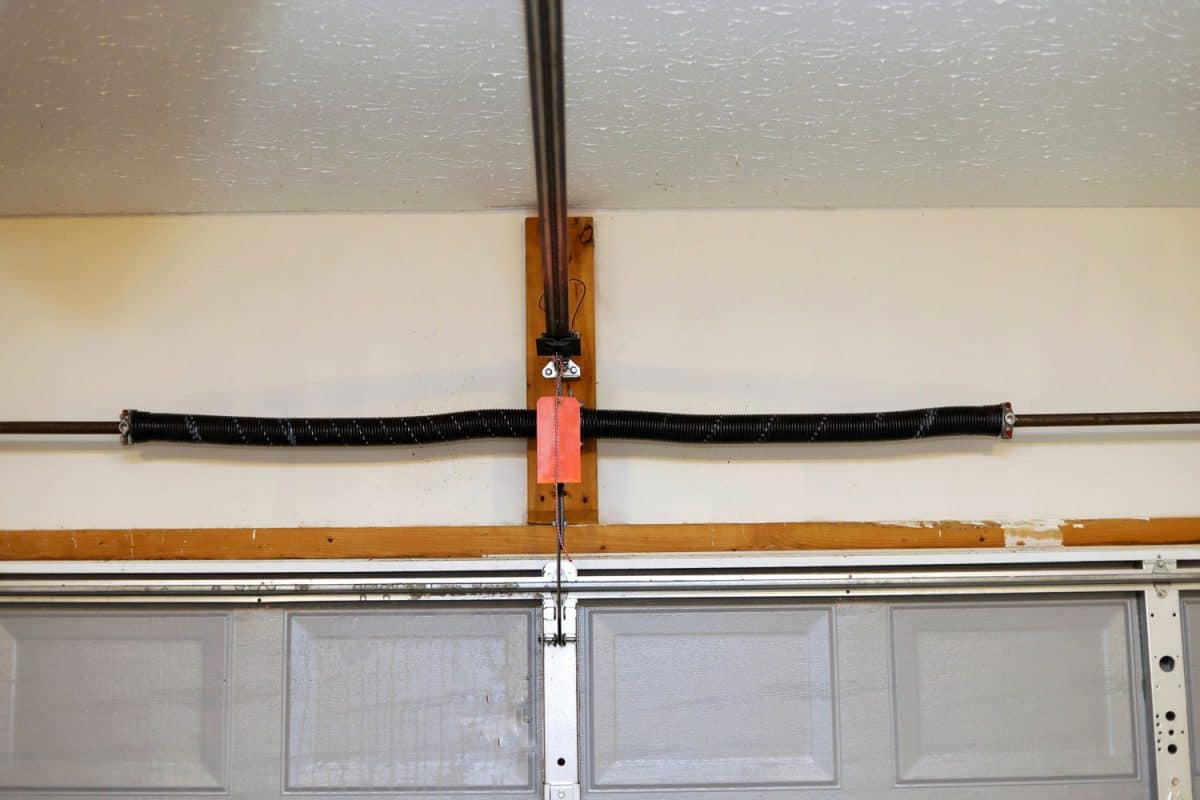 A close up image of a the springs on a overhead garage door opener, Should You Lubricate Garage Door Springs?
