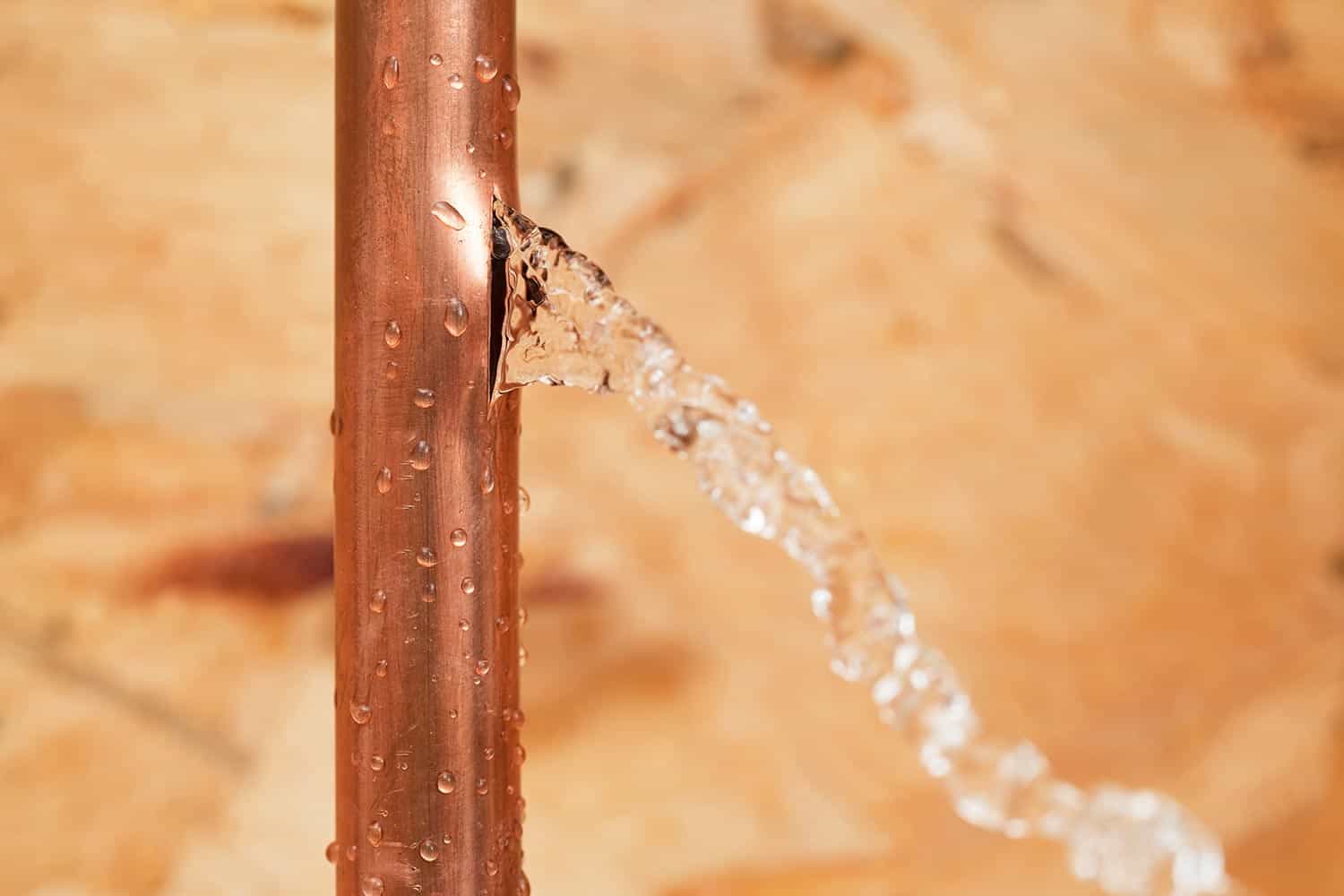 A cracked household copper water pipe
