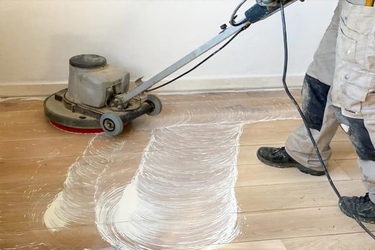 Worker cleaning and buffing floor, How Soon Can You Buff A Floor After Waxing?