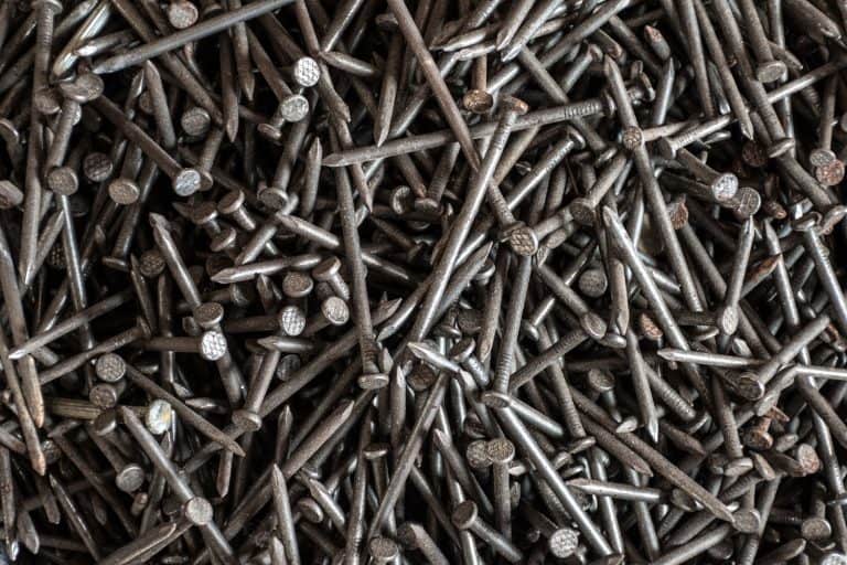 A photo of lots of different nails on a small box, 20 Types Of Nails And Screws