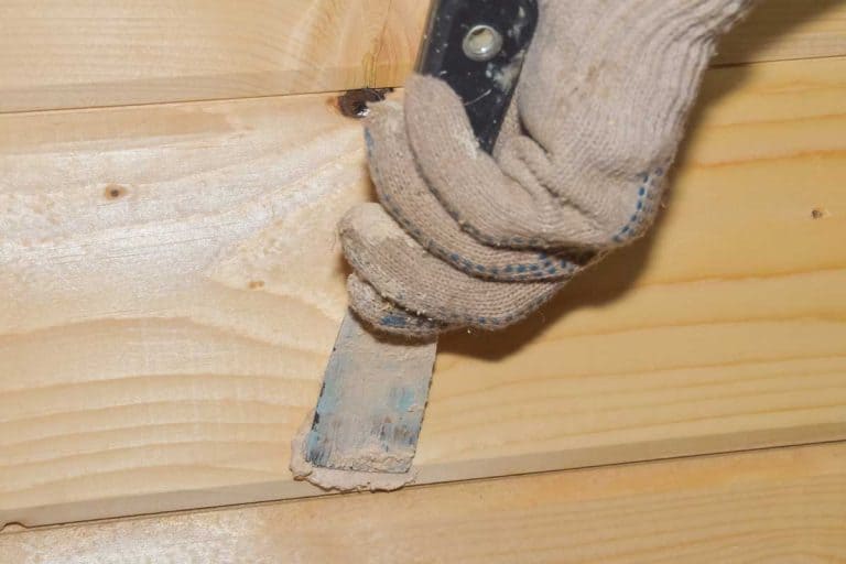 Worker puts putty on a hole in a wooden wall, How To Stain Wood Filler To Match Floor