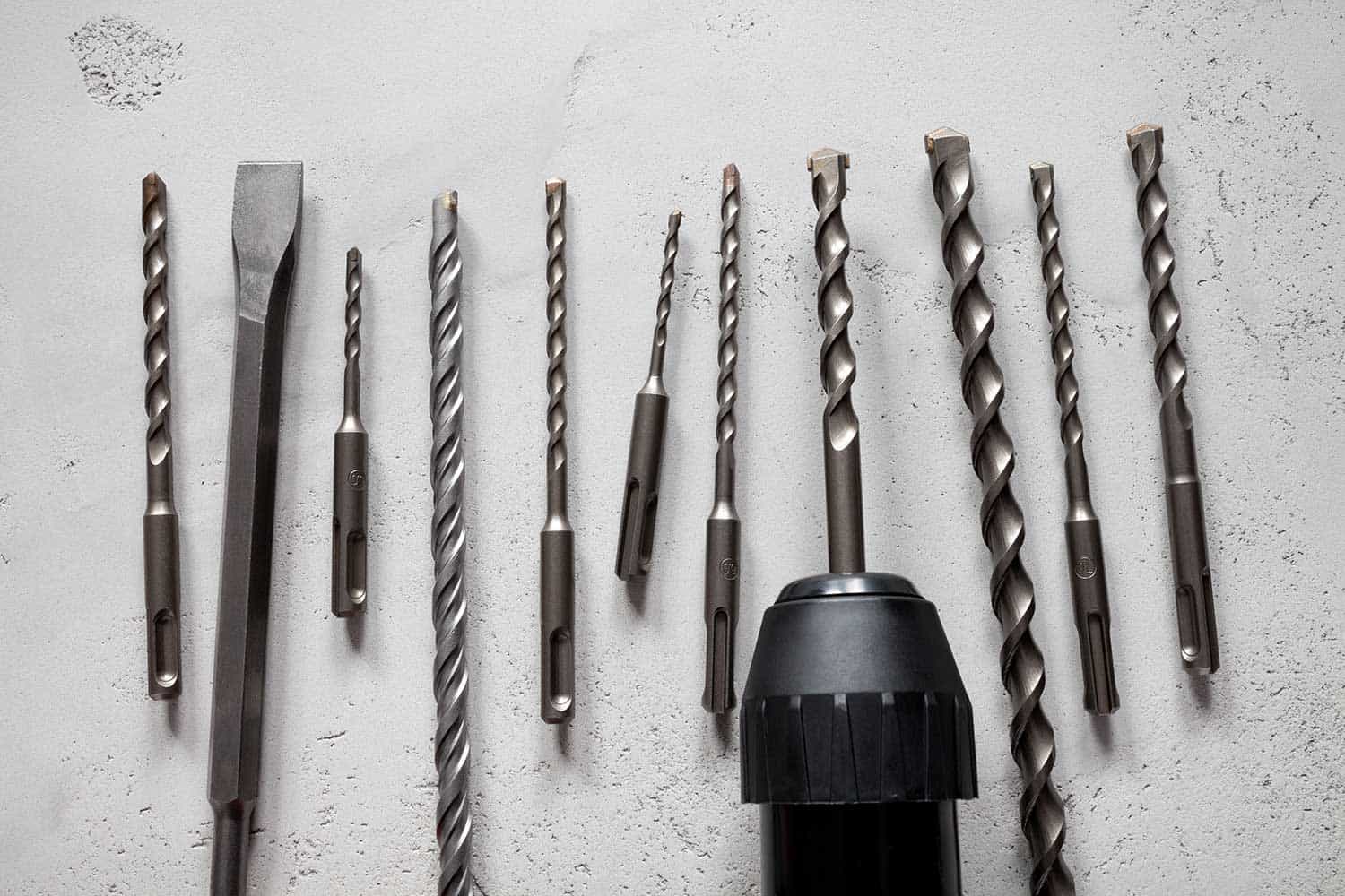 Close up of drill bits on concrete background