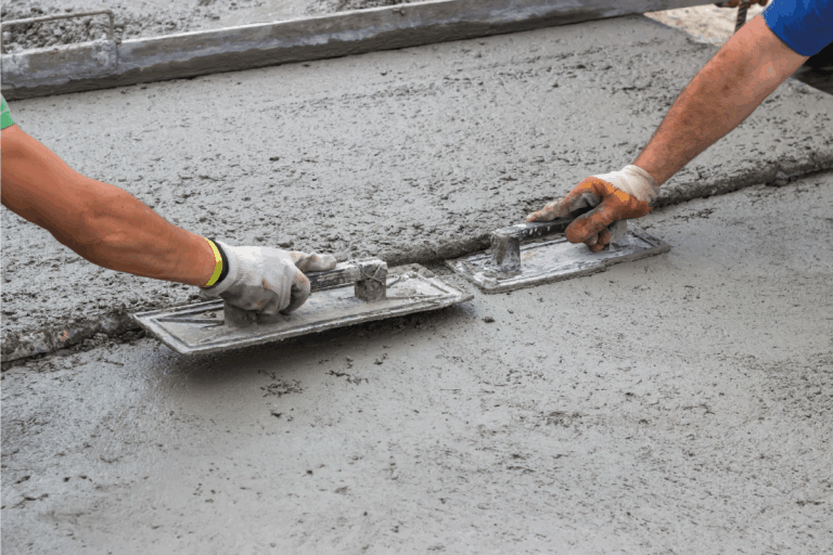 Leveling-concrete-with-trowels.-How-To-Pour-A-Concrete-Floor-For-An-Existing-Garage