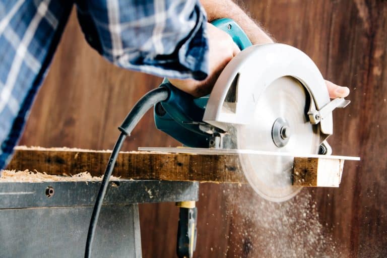 A carpenter using a rotary saw in his wood working project, Can A Rotary Saw Cut Wood? [And How To Do That]