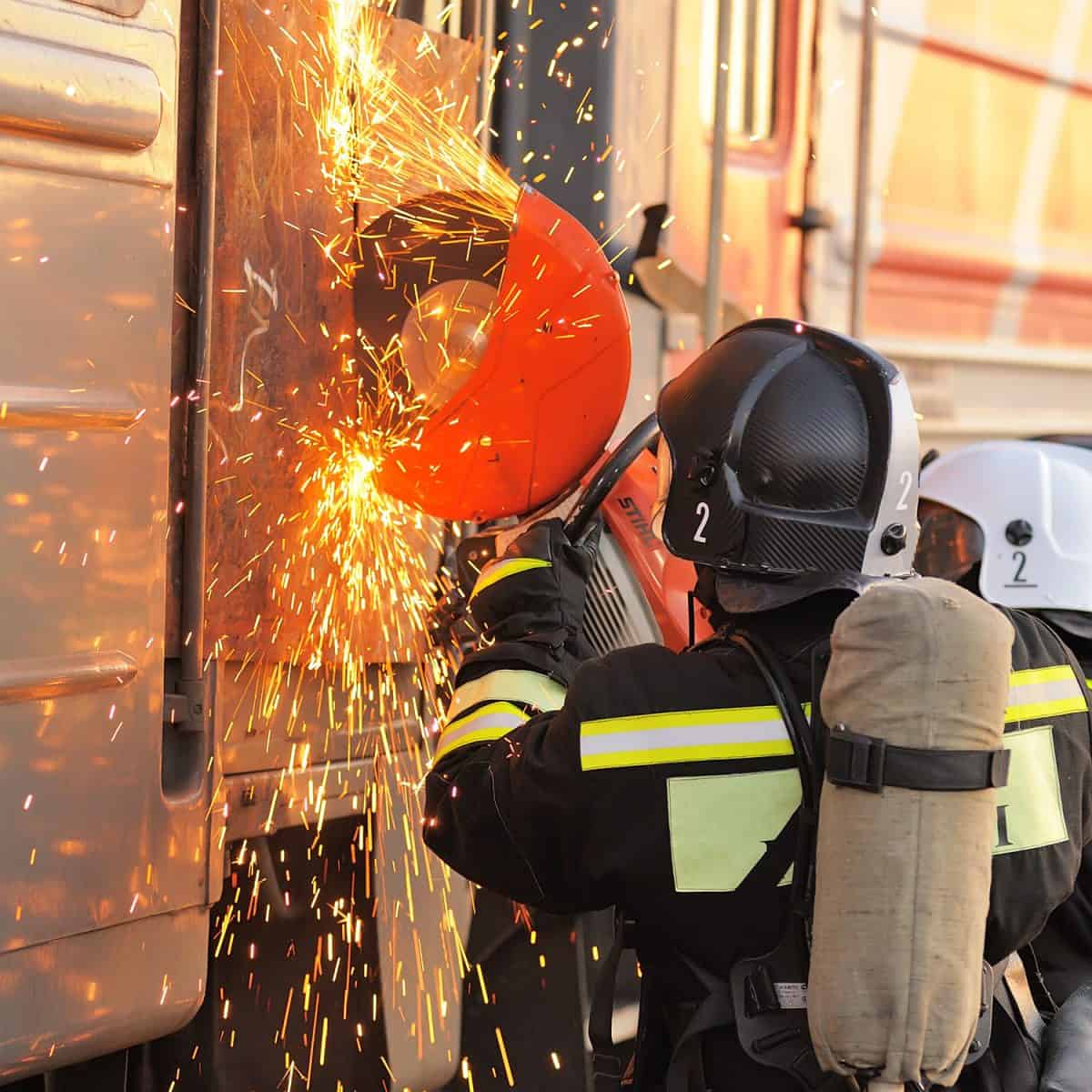 A fireman using a rotary saw in their emergency fire excercise