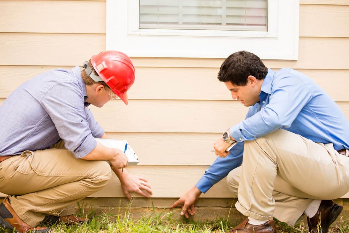 Inspectors or blue collar workers examine building wall, foundation, How To Take Care Of Your House Foundation [A Complete Guide]