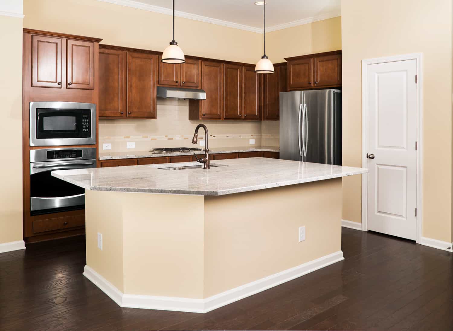 Kitchen with Dark hardwood flooring with walnut cabinets