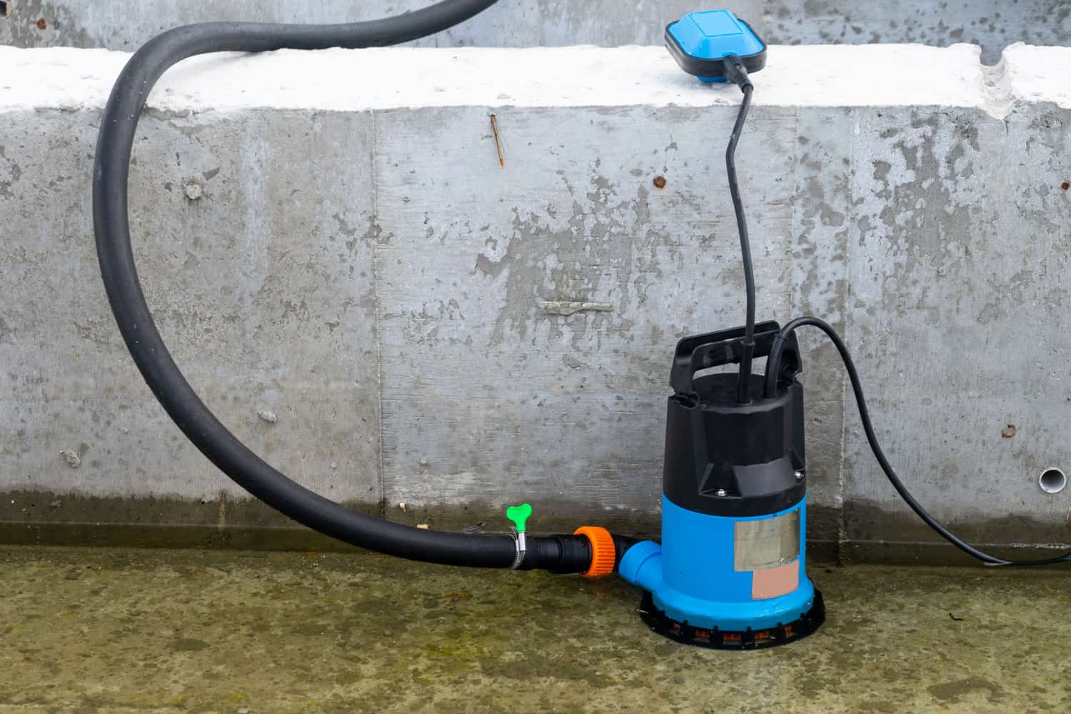 A submersible water pump being used in removing water in a flooded area of the construction site, How Long Does It Take To Replace A Well Pump?