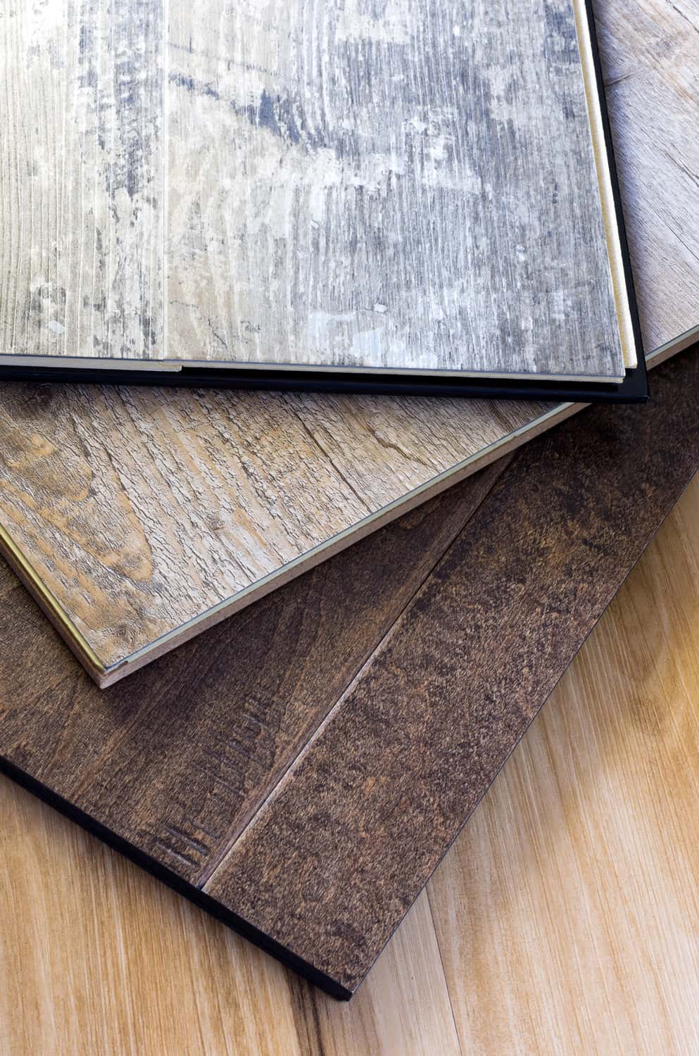 engineered tongue in groove hardwood floor planks of various styles and finishes in a stack
