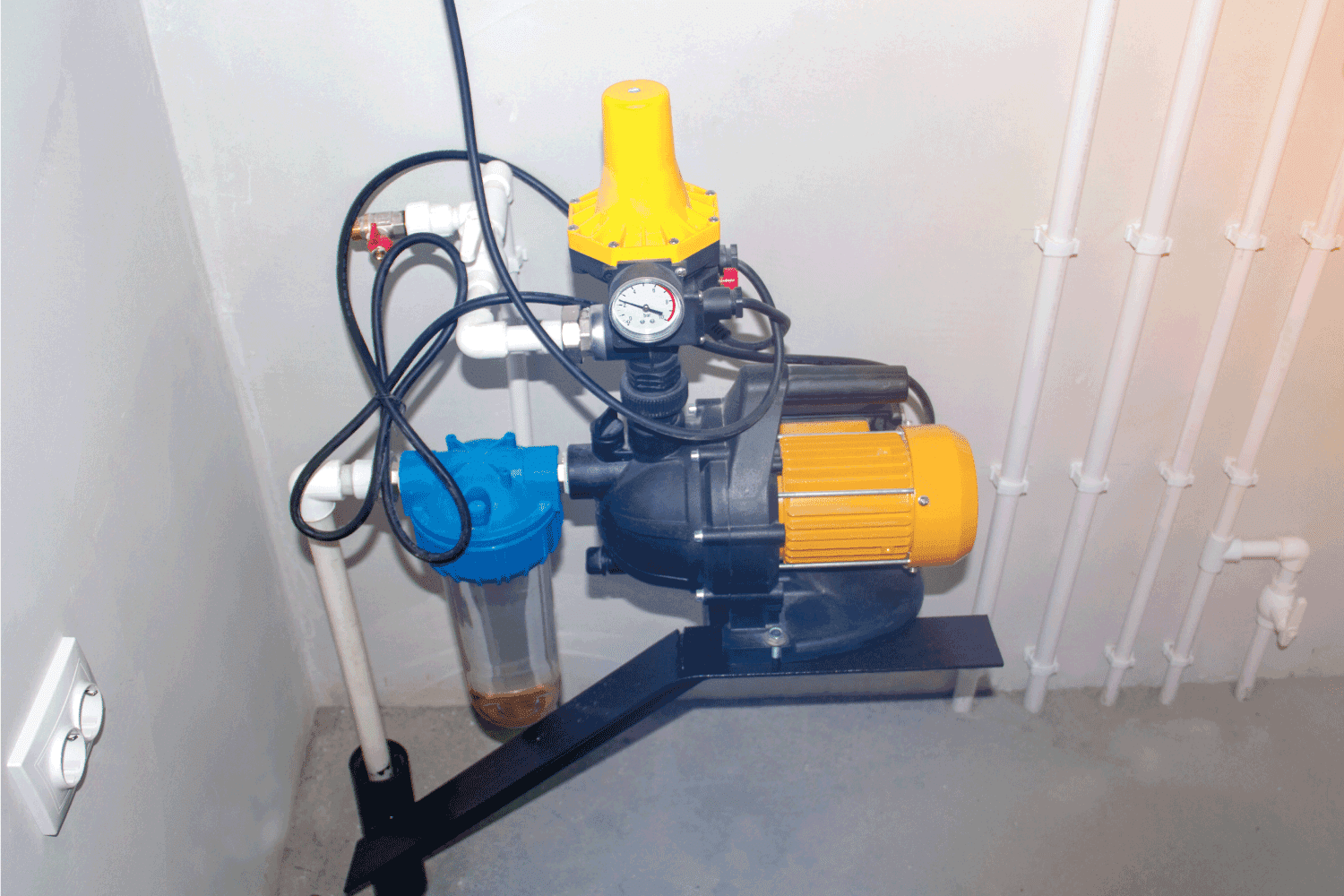 motor for a water pump in a pump room against a white wall. How Often Should A Well Pump Cycle