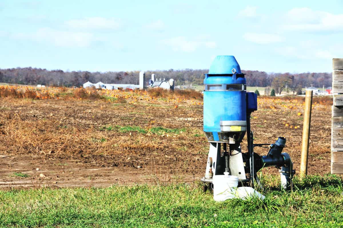 A blue colored well pump photographed in the field