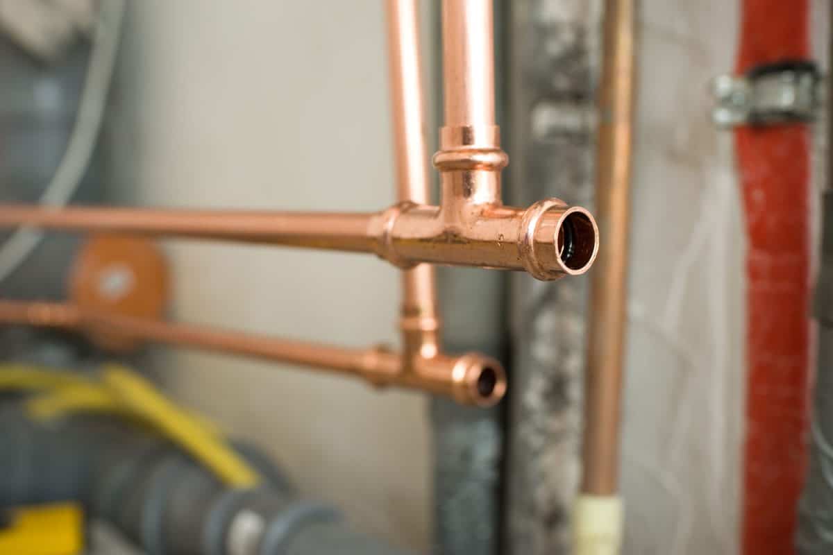 A detailed photo of a copper pipe water line