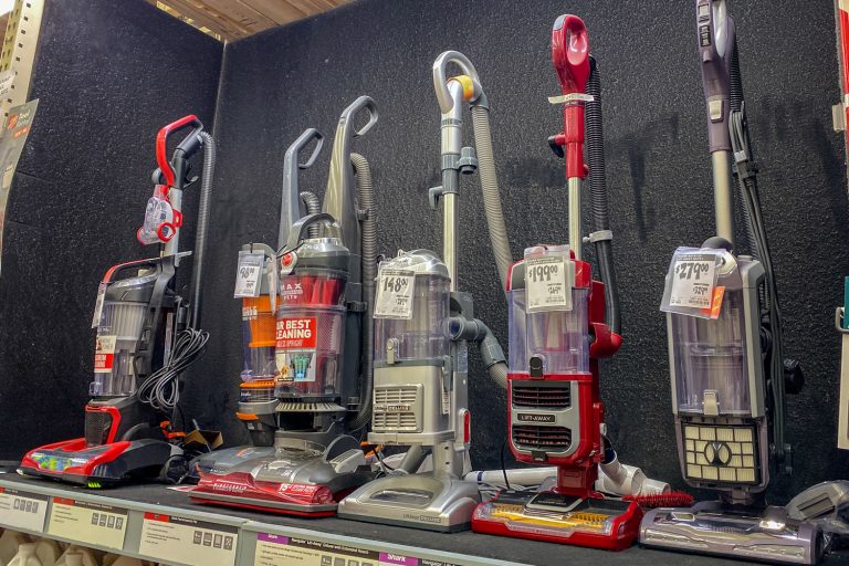 A display shelf of vacuums for sale at a Home Depot store, Do Shark Vacuums Have Height Adjustments For Carpet?
