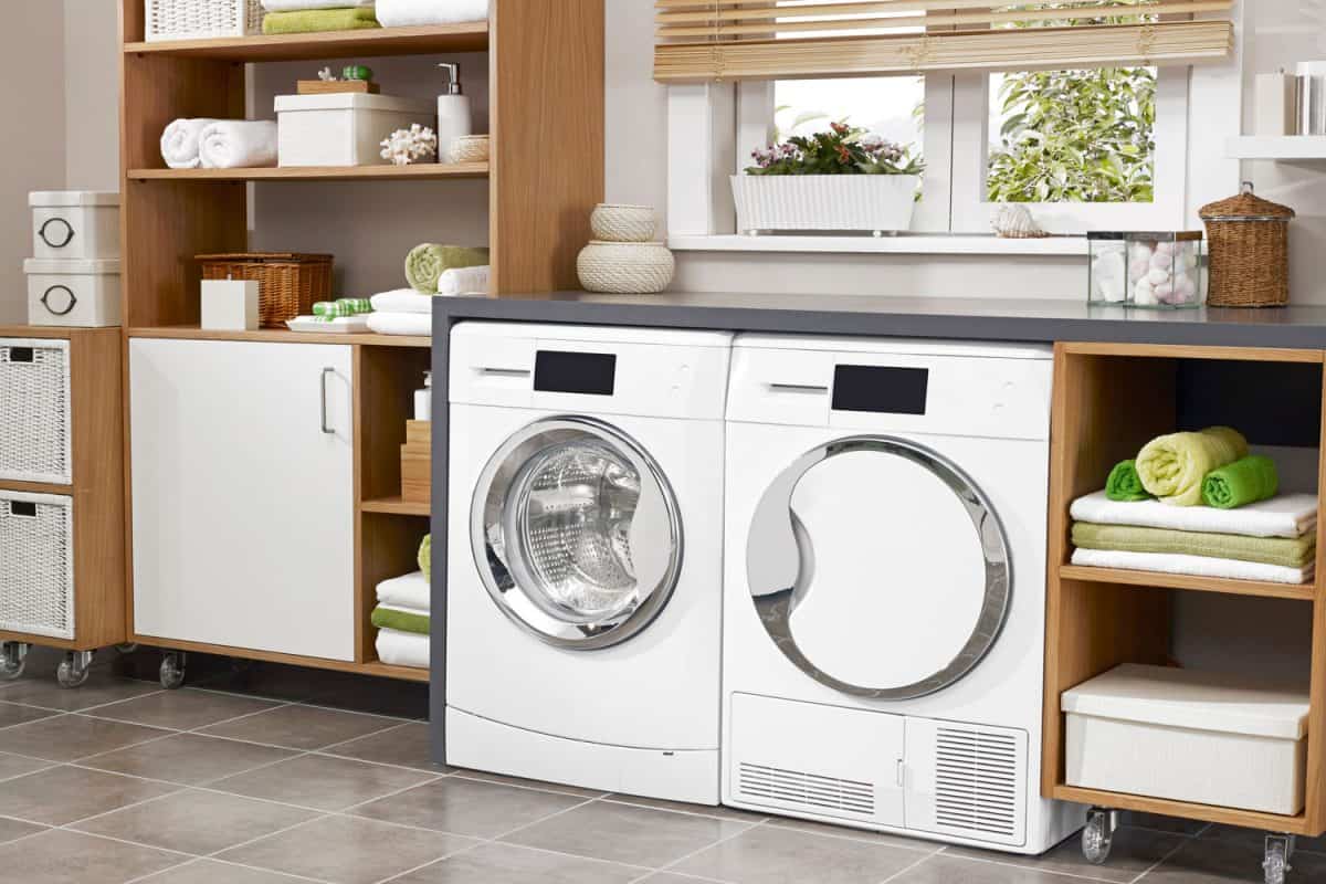 A minimalist themed laundry room with white washing machine and dryer