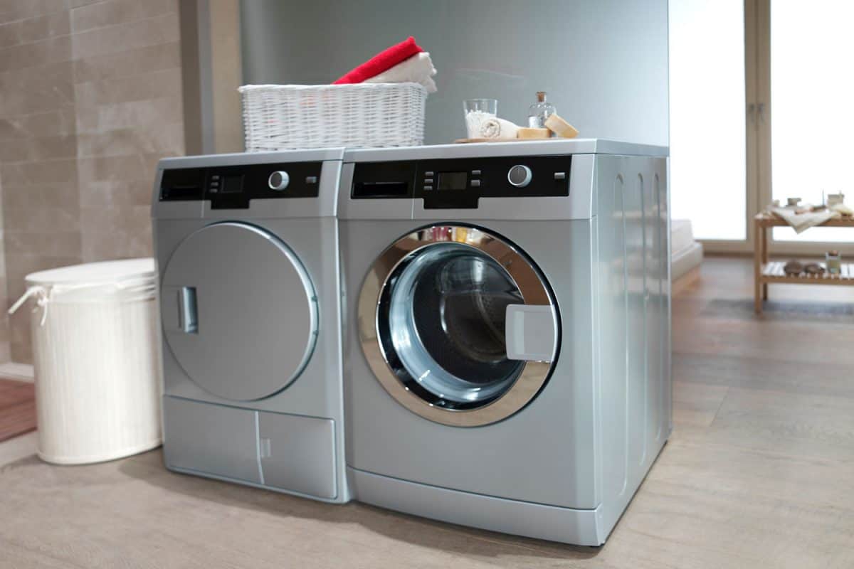 Gray colored washing machine and dryer inside the laundry room