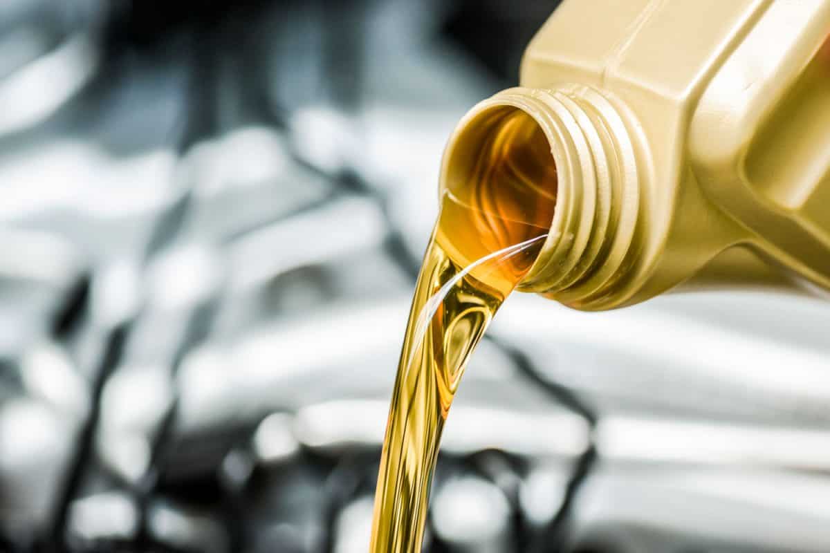 Pour motor oil to car engine. Fresh yellow liquid change with back light. Maintenance or service vehicle concept