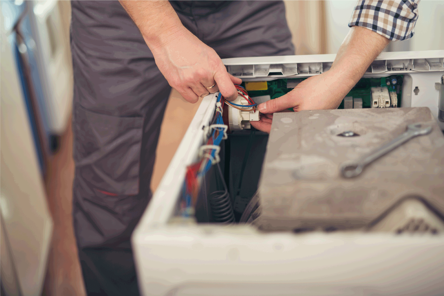 Technician repairing a washing machine power supply