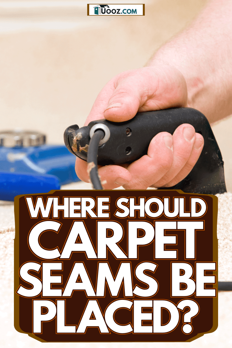 A carpet installer joining two pieces of carpet using a seam iron, Where Should Carpet Seams Be Placed?