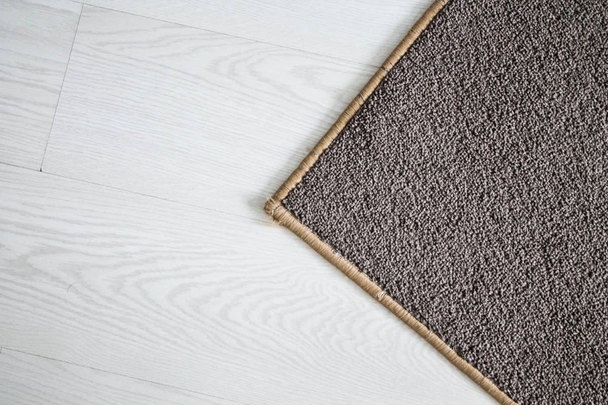 A hard carpet over white laminated flooring