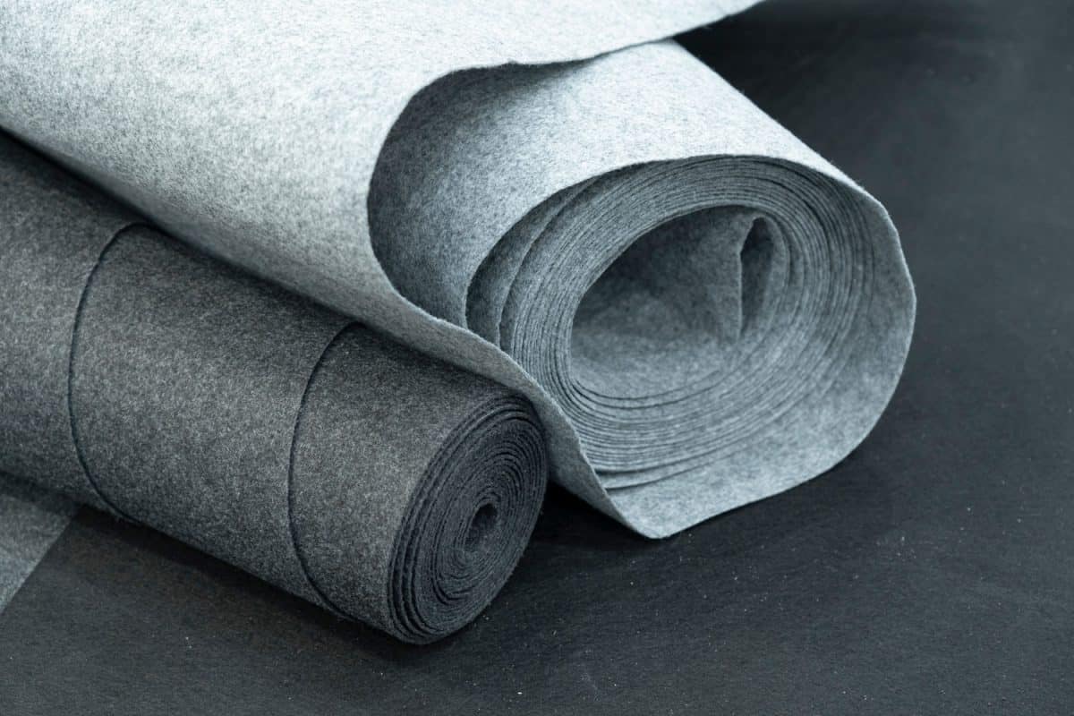 Close up of carpet rolls. Polyester or felt carpets background