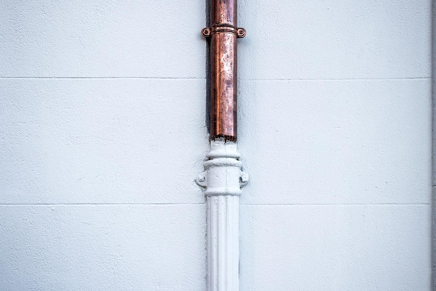 Copper and white painted pipes junction
