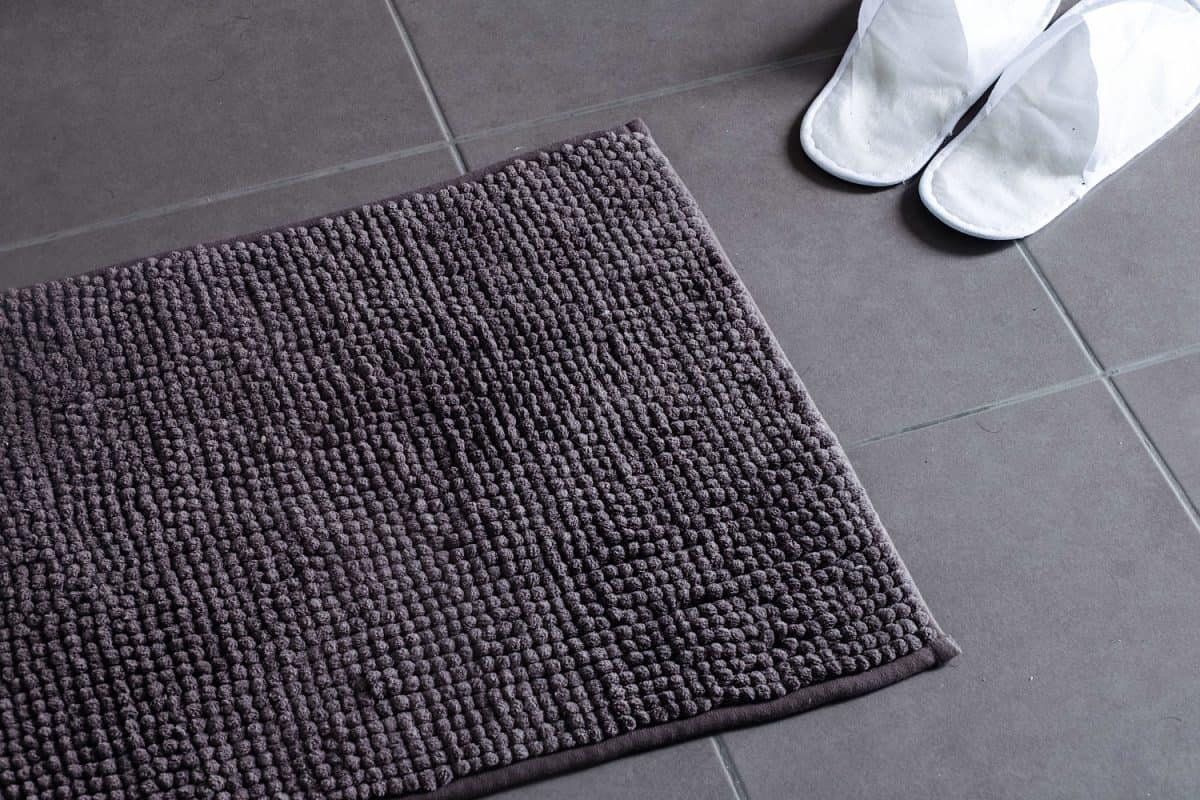 Door mat with slipper shoes on clean floor
