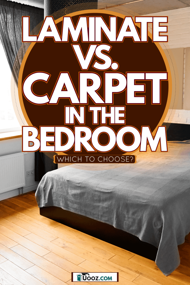 A small modern bedroom with wooden flooring gray beddings and curtains with white painted walls, Laminate Vs. Carpet In The Bedroom: Which To Choose