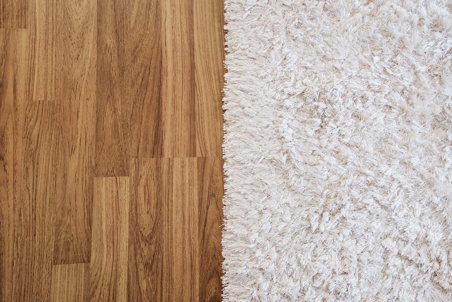 Luxury white carpet on laminate wood floor in living room