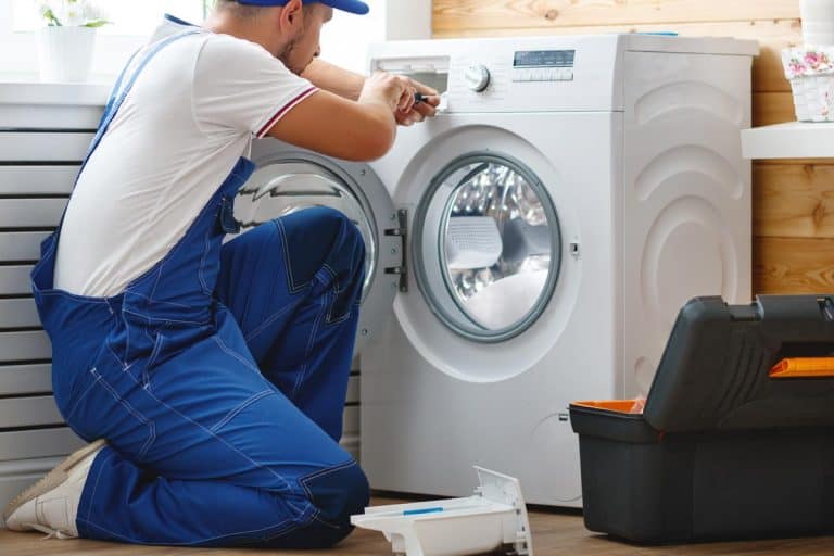 Man repairs a washing machine, Whirlpool Dryer Won't Start - What To Do?