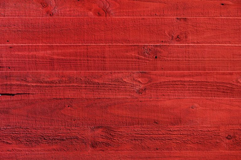 Up close photo of wood painted in color red, Can You Use Wood Paint On Walls