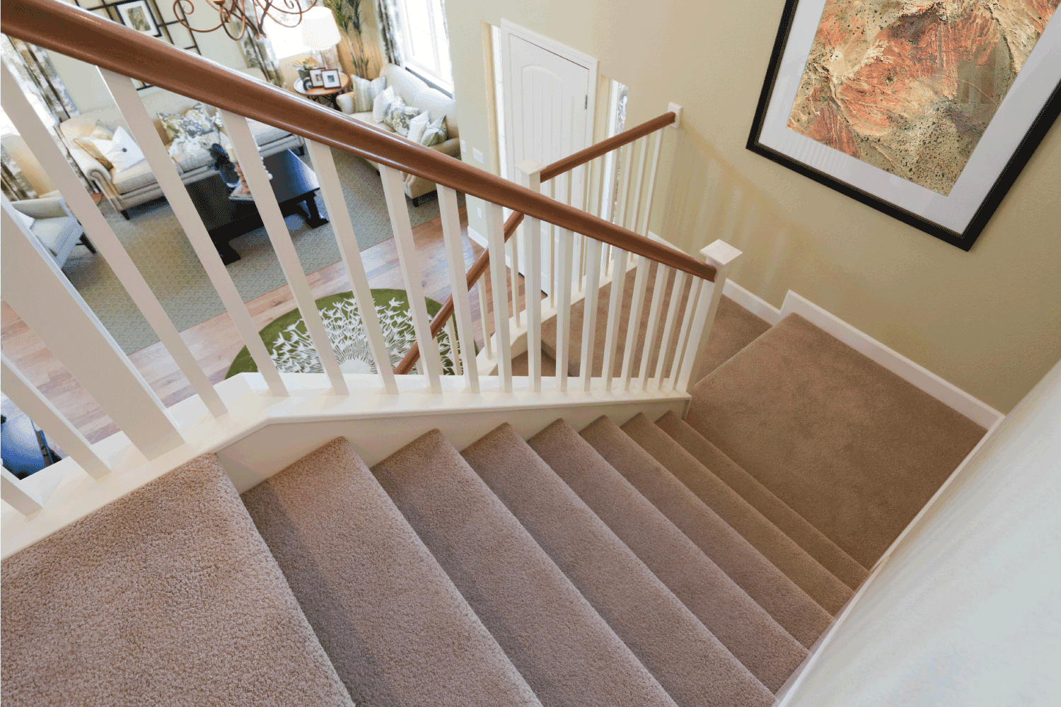 View down interior carpeted stairs in a modern American home.