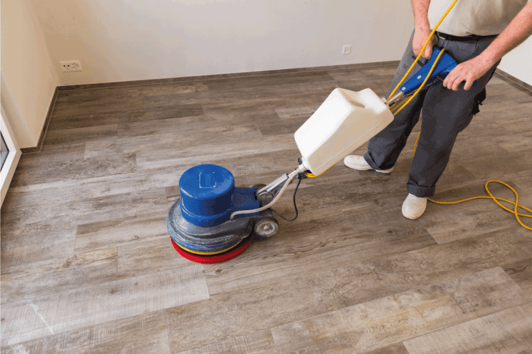 man using rotary polisher on hardwood flooring. Can You Use Carpet Shampooer On Hard Floors