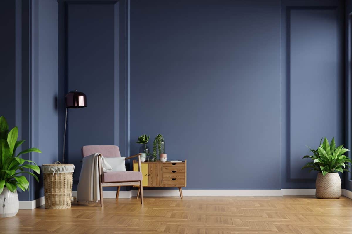 A blue accent wall with pattern laminated flooring matched with nice colored furniture's