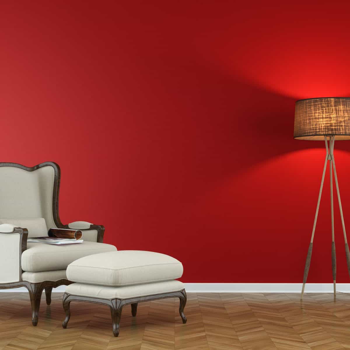 A red colored wall with diagonal laminated flooring