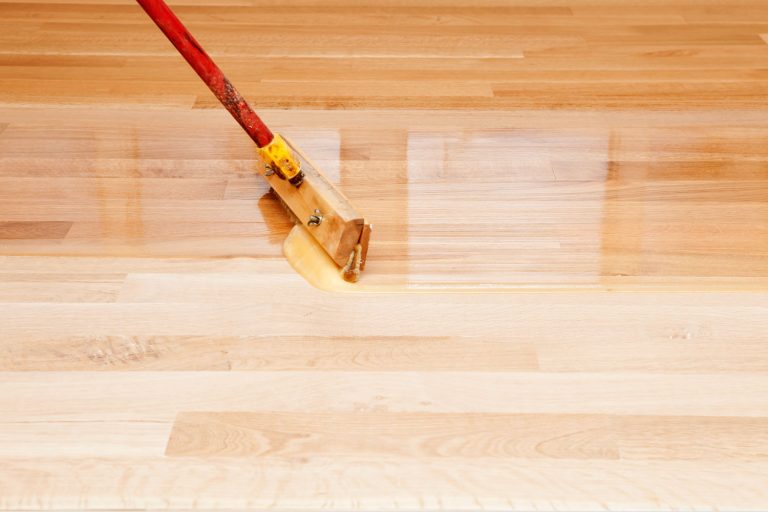 Applying polyurethane on the wooden floor to make it shine, Can You Paint Over Polyurethane? [Even Without Sanding]