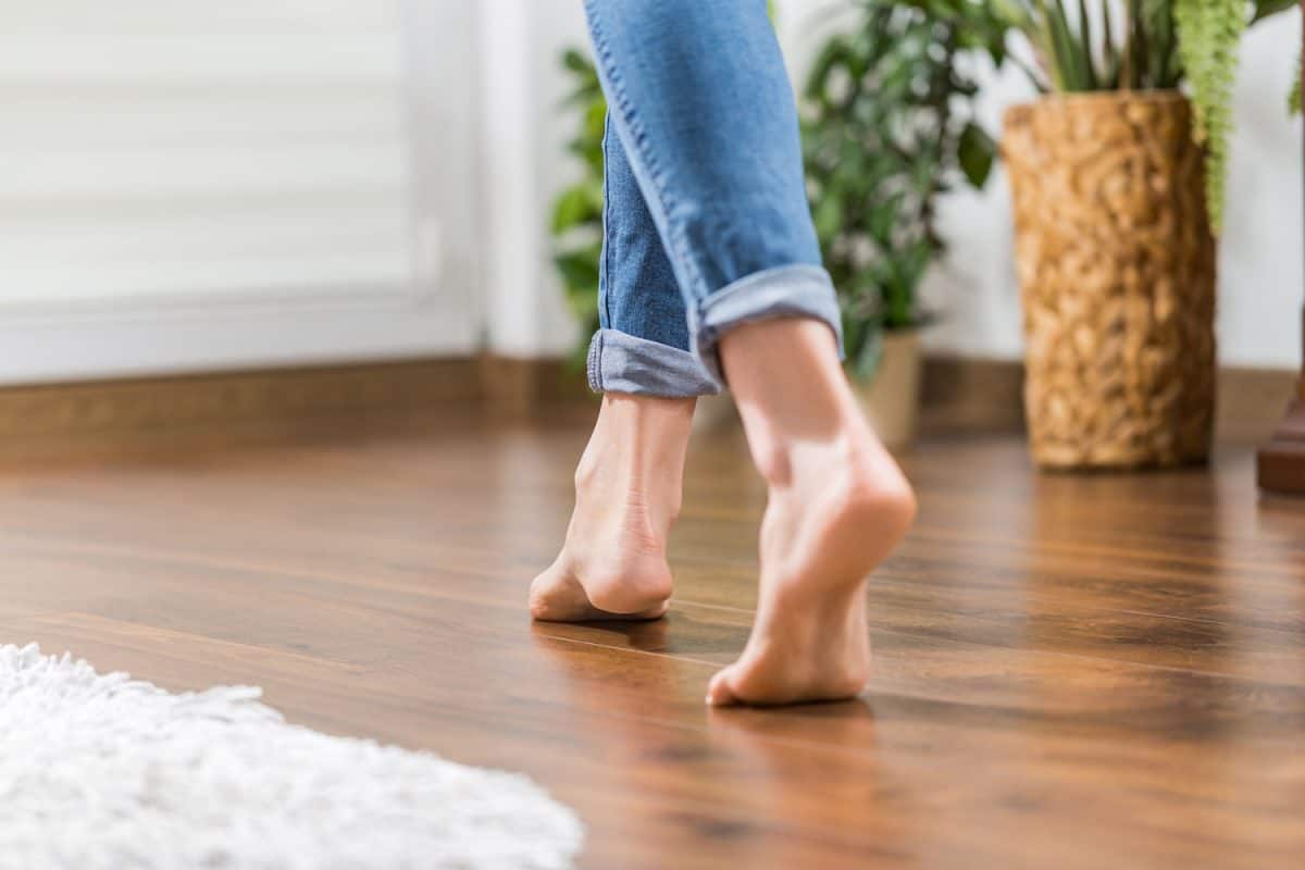 Barefoot woman walking barefoot on the hardwood floor