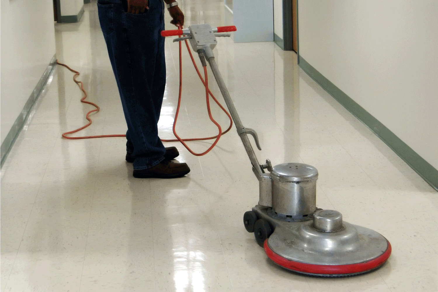 Commercial floor buffing machine in a hallway