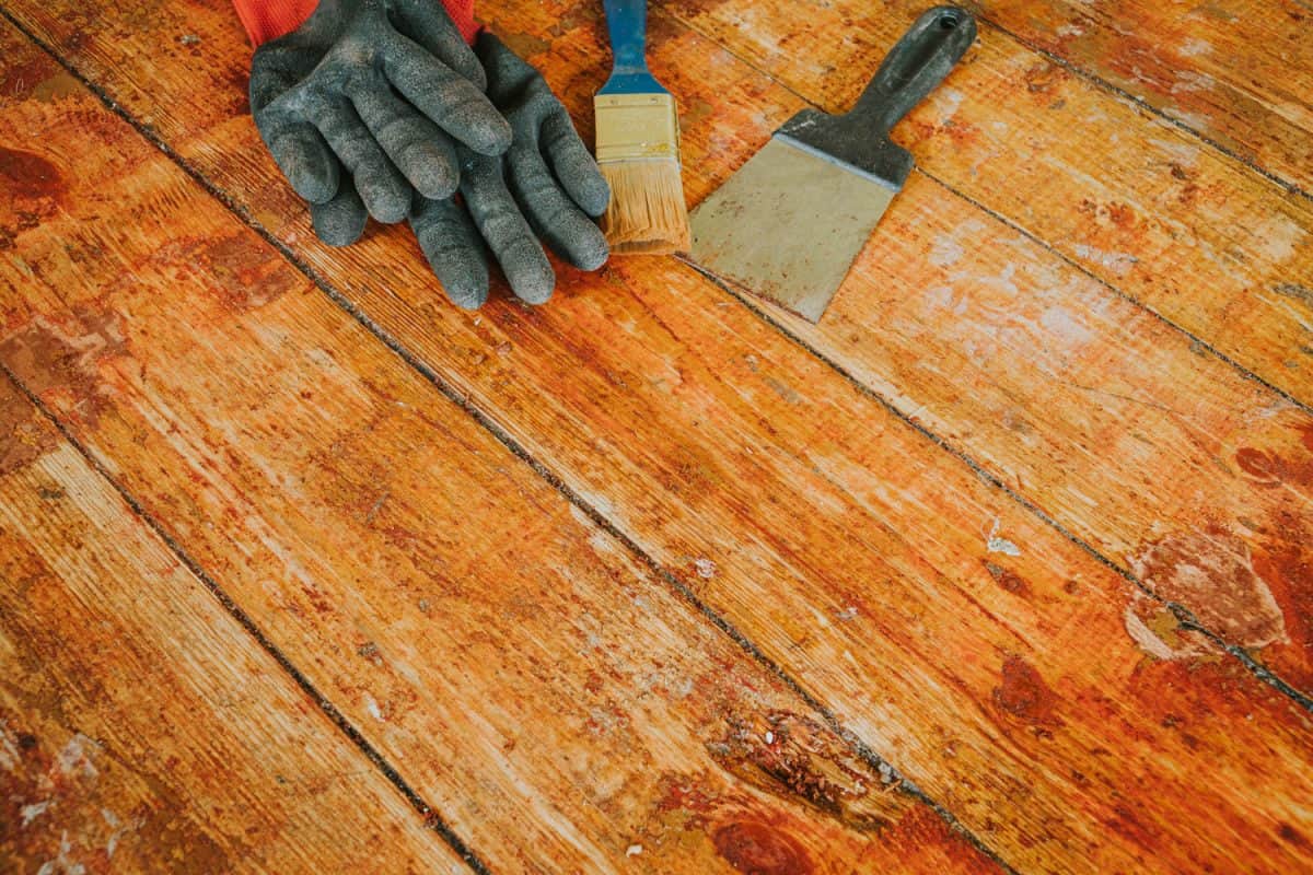 Gloves and painting materials on the wooden floor